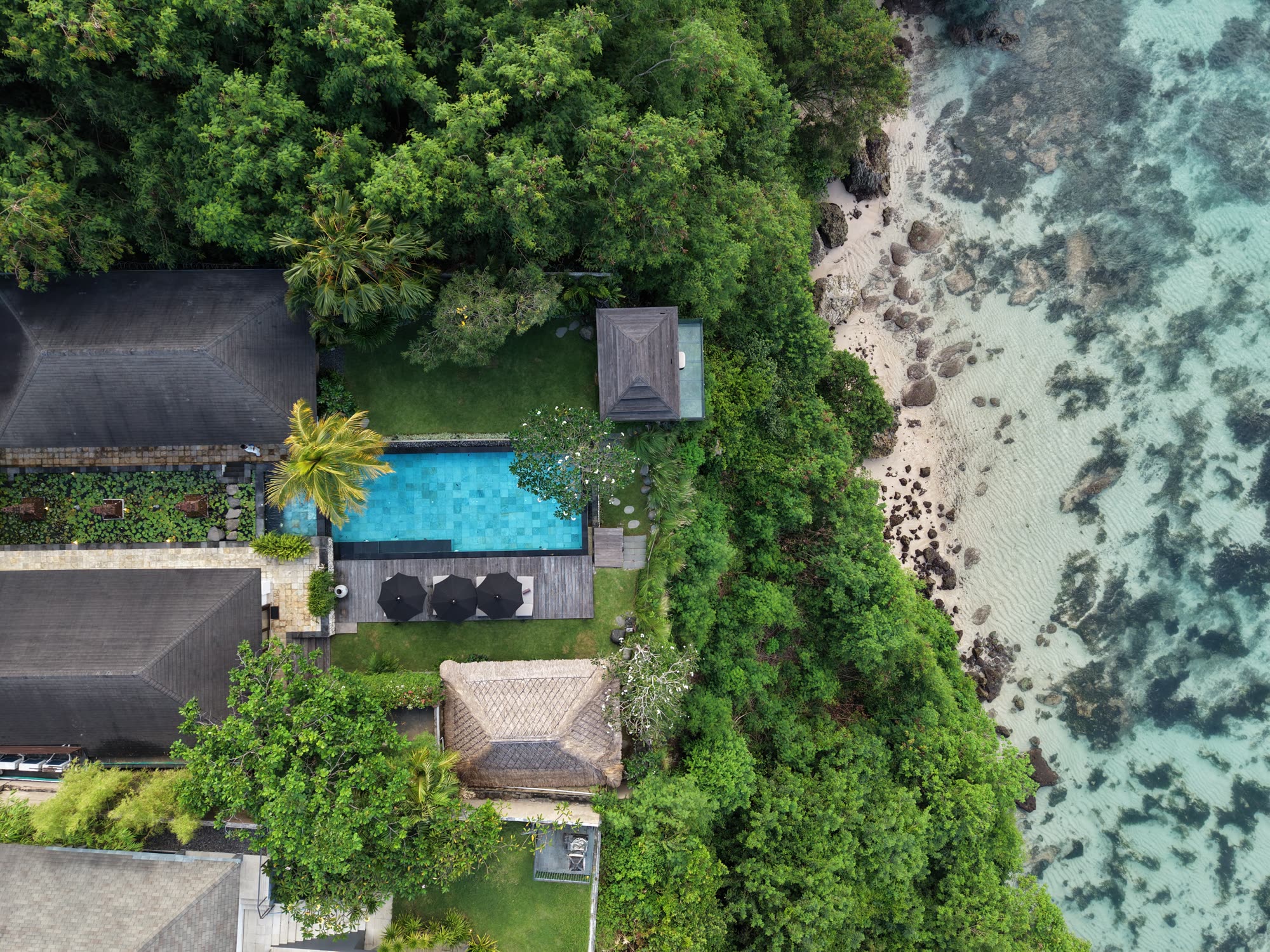Bird's-eye aerial of villa and cliff
