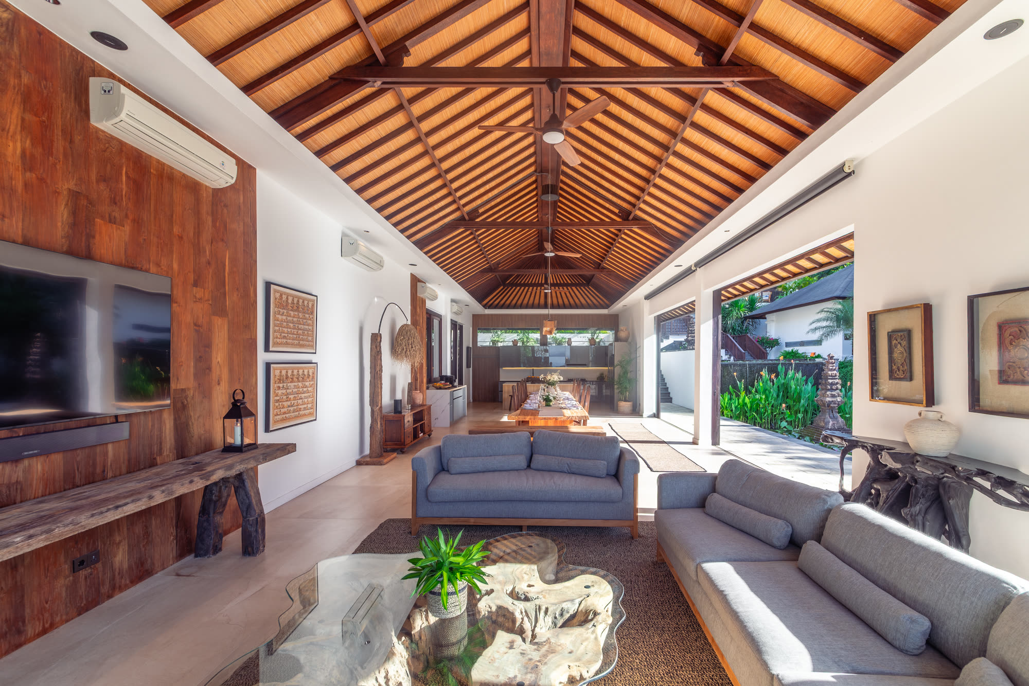 Open-plan living and dining under a vaulted timber roof