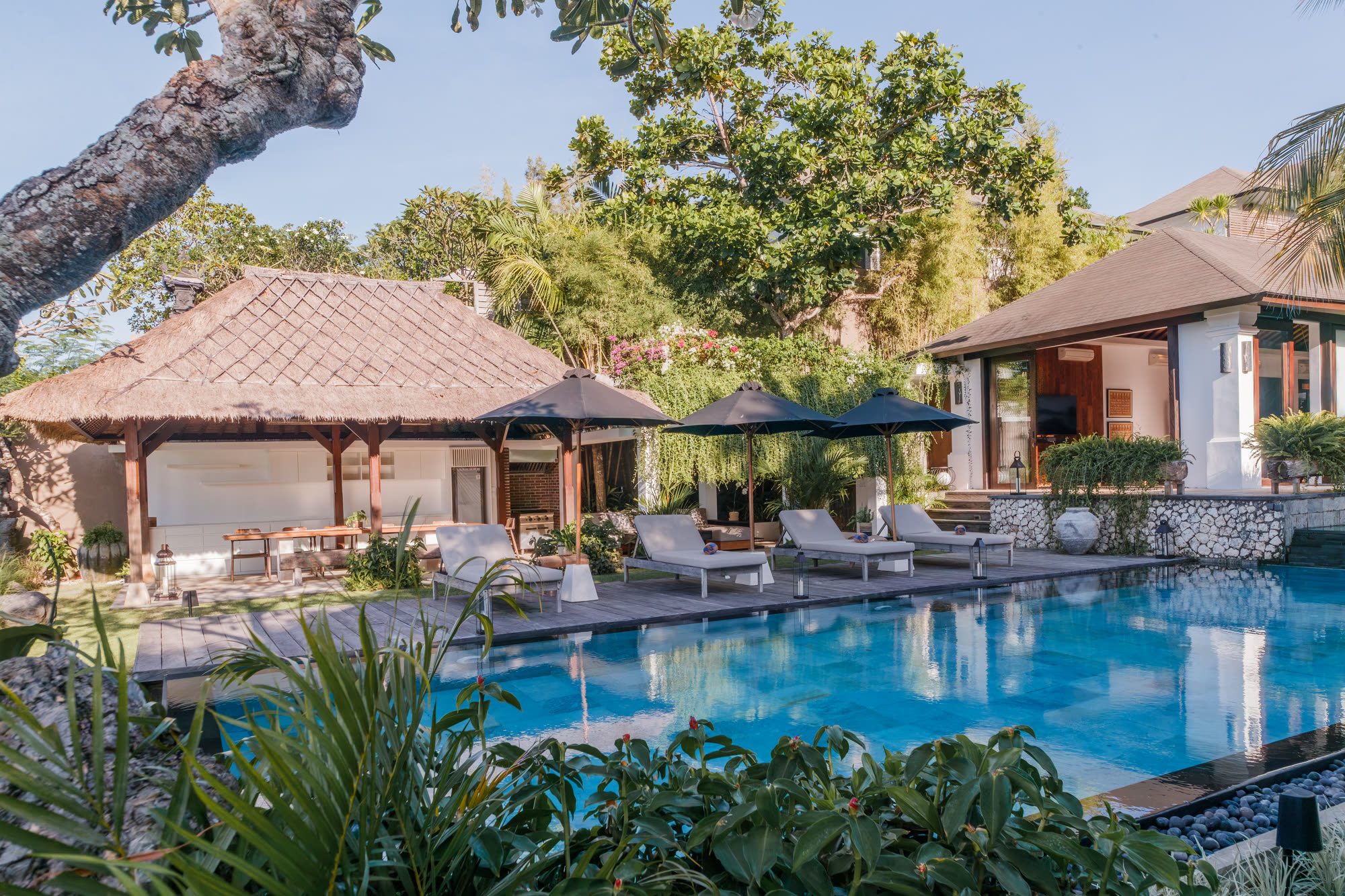 The pool deck and thatched dining pavilion