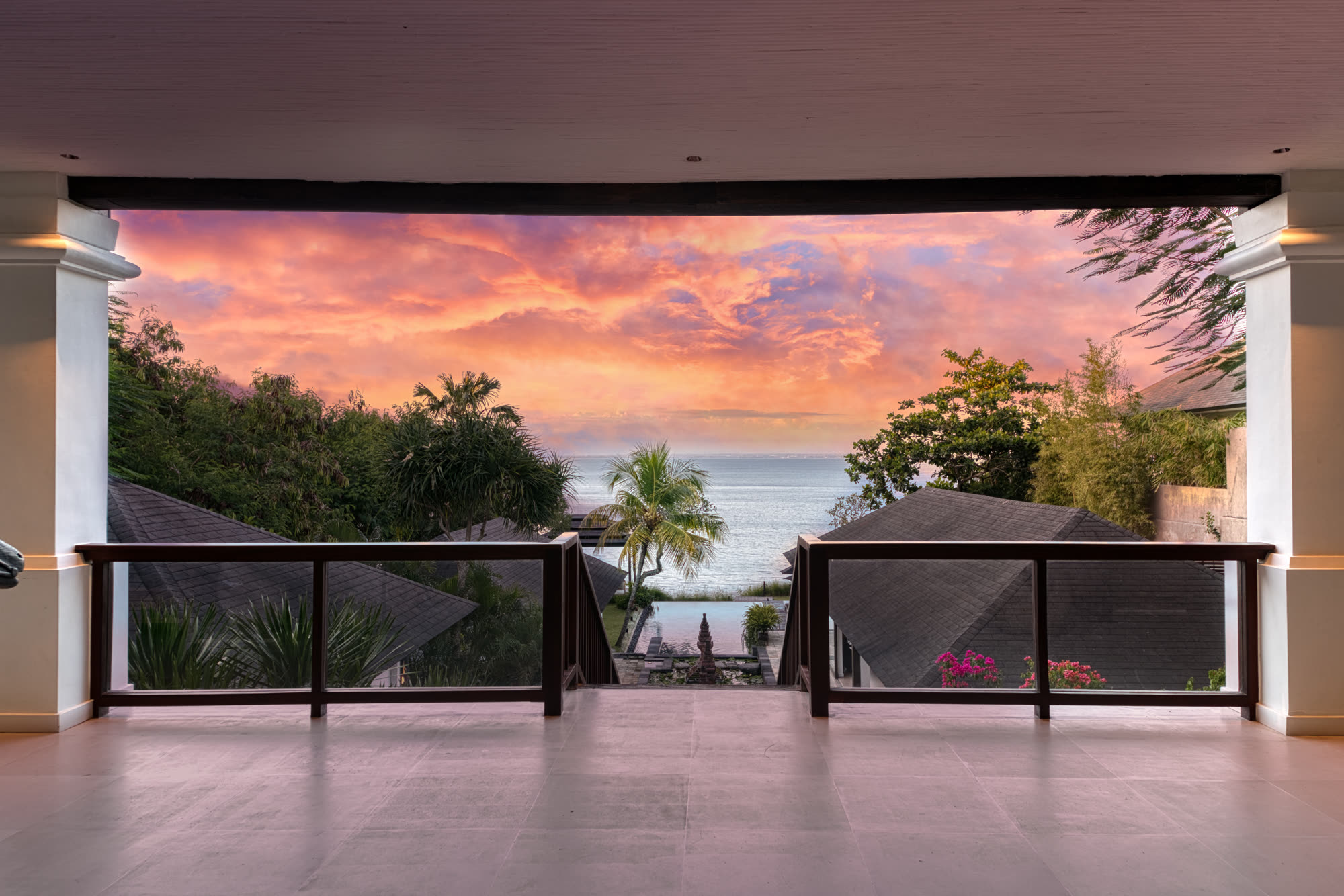 The upper verandah at sunset, looking down over the estate to the ocean
